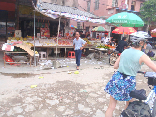 Terry walks her bike through another Village Market.